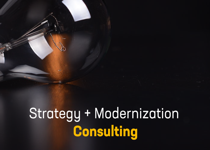 text saying strategy + Modernization consulting and background is a dark room with the upper half of a lightbulb on a floor